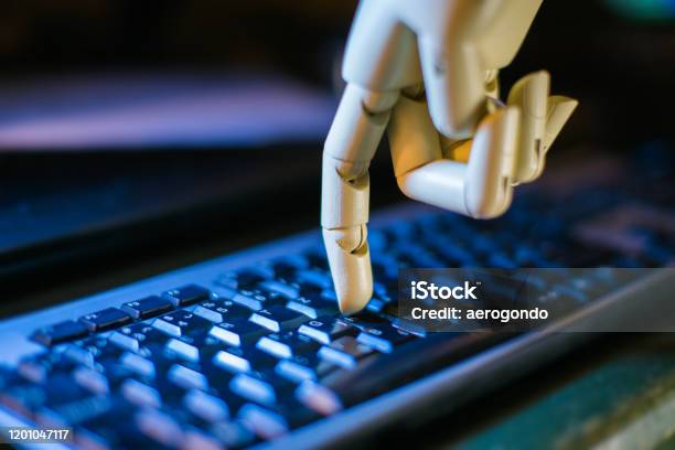 Robost Hand Using Computer Robotic Hand Using A Computer Keyboard Stock Photo - Download Image Now ...