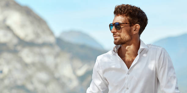 Young Handome man in white shirt relaxing Young handsome man in daily summer outfit relaxing in Italy during vacation hot handsome man stock pictures, royalty-free photos & images