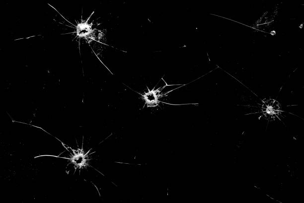 istock holes in the glass with cracks isolated on a black 1201049971
