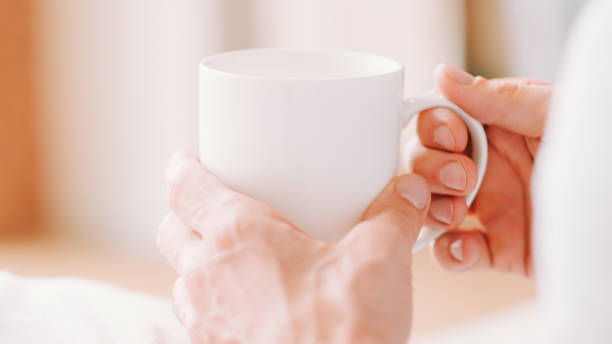 istock morning coffee man holding white mug hot drink 1201050154