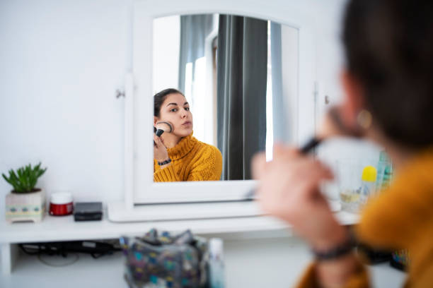 istock Young Latino Woman Applying Makeup 1201050323