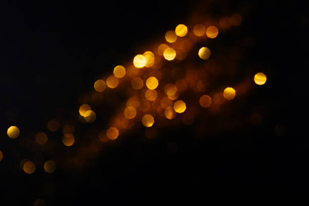 istock Beautiful blurred golden background on black 1201050521