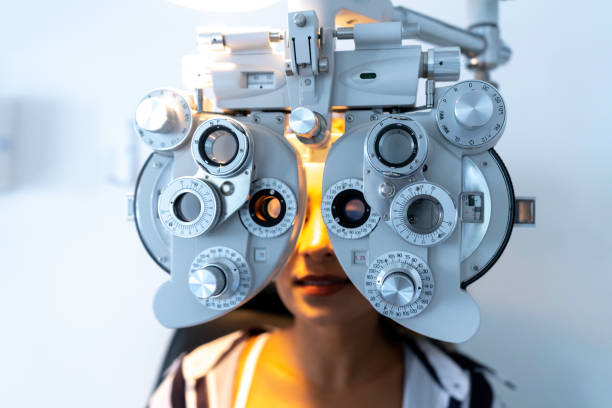 istock Women doing eyesight measurement with optical phoropter in ophthalmology clinic 1201050579