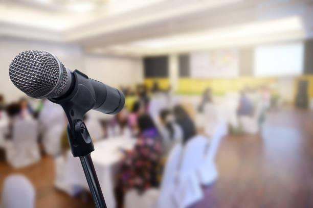 istock Microphone over the blurred business forum Meeting or Conference Room Concept, Blurred background. 1201053169