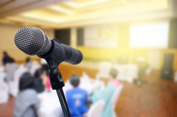 istock Microphone over the blurred business forum Meeting or Conference Room Concept, Blurred background. 1201053170