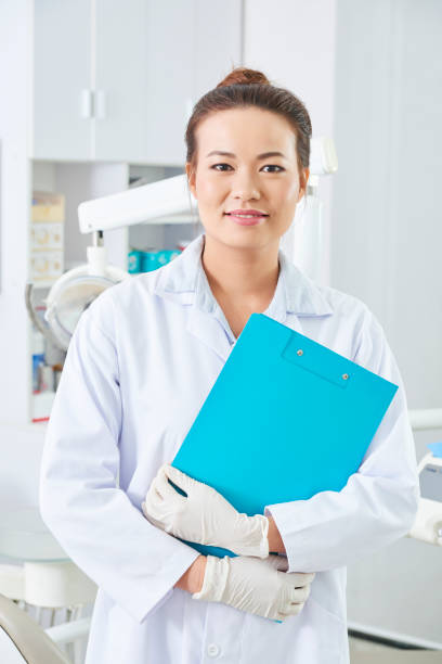 istock Dentist With Clipboard Portrait 1201053502