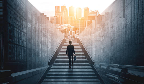 istock Ambitious business man climbing stairs to success. 1201073942