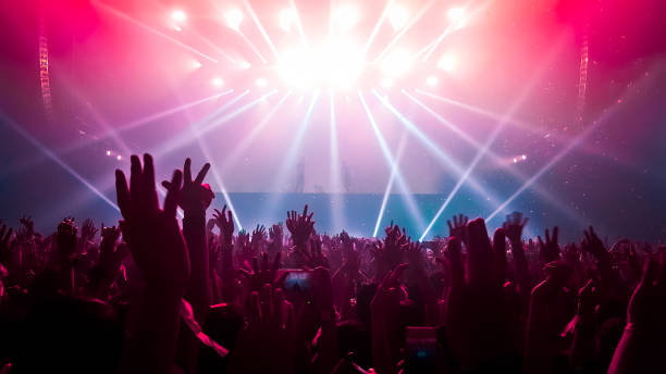 Happy People Dance in Nightclub Party Concert Happy people dance in nightclub DJ party concert and listen to electronic dancing music from DJ on the stage. Silhouette cheerful crowd celebrate New Year party 2020. People lifestyle DJ nightlife. rock musician stock pictures, royalty-free photos & images