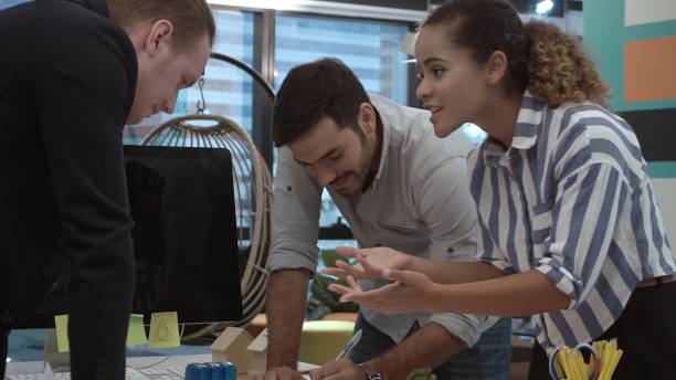 istock Creative business people group having conversation at office desk in workplace. 1201076033