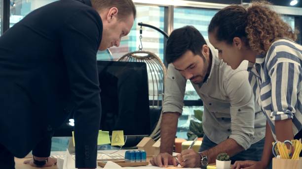 istock Creative business people group having conversation at office desk in workplace. 1201076738