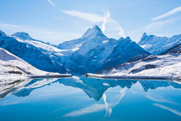 Switzerland, reflection of Firist Bachalsee Lake. The Alps reflected in the snowy Bachalsee Lake. switzerland stock pictures, royalty-free photos & images