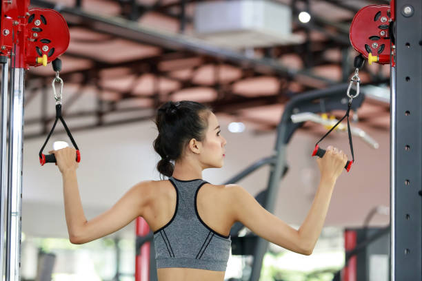 istock Fitness woman exercise with exercise-machine Cable Crossover in gym 1201081870