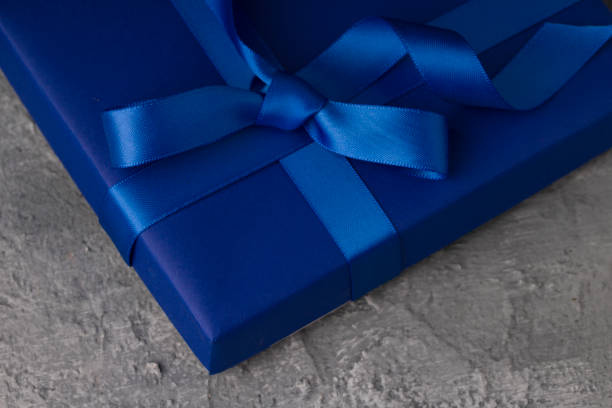 istock Blue gift box on concrete background. close up 1201092927