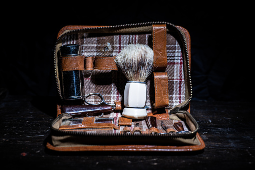 Shaving brush, shaver and other accessories in a toilet bag