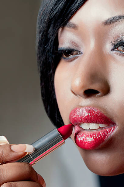 istock Young beautiful woman applying red lipstick 120109715