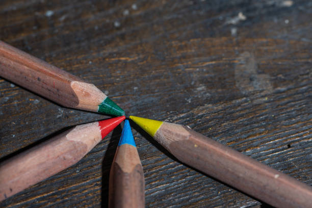 Colored pencils on an old vintage style wooden surface