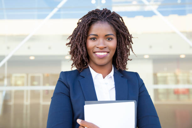 istock Happy young businesswoman holding folder 1201101589