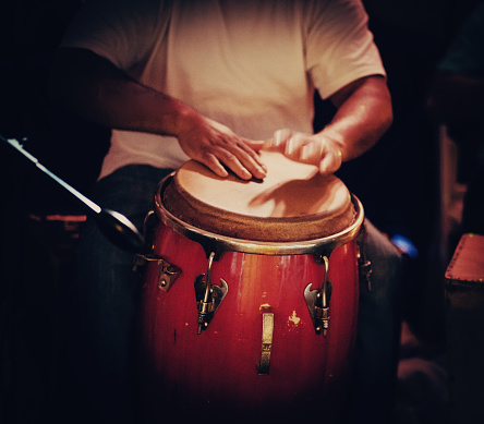 Detail of hands playing latin percussion (tumbadora or congas)
