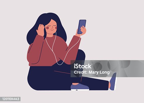 istock Young woman is listening to music or audio book with headphones on her smartphone 1201104443