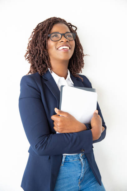 istock Content businesswoman holding papers and looking up 1201106048