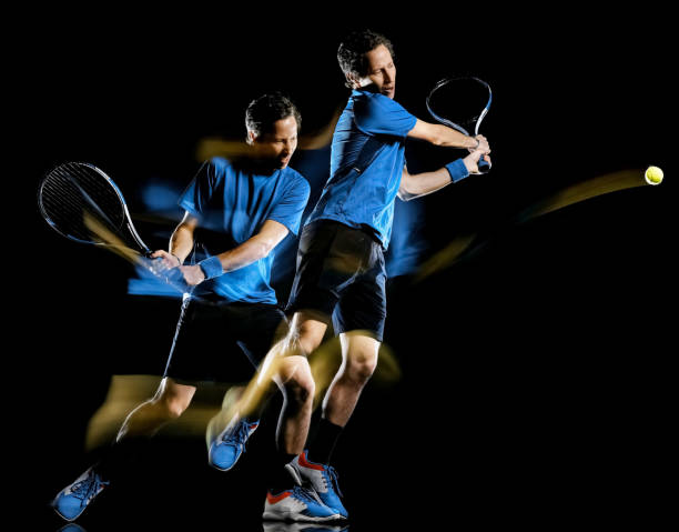 istock tennis player man isolated black background light painting speed motion 1201107784