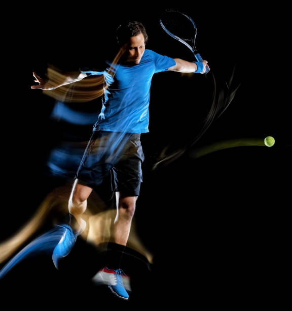 istock tennis player man isolated black background light painting speed motion 1201107795
