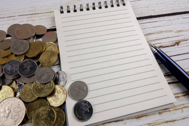 istock Pen,notebook,coins and coffee. General concept of business. Copy space 1201110736