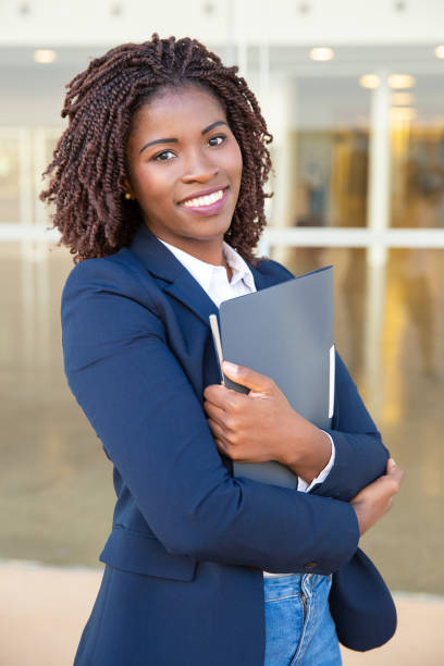 istock Cheerful businesswoman holding folder 1201110869