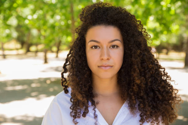 istock Beautiful curly woman standing and looking at camera 1201111226