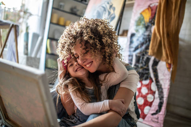 Mother and daughter painting together