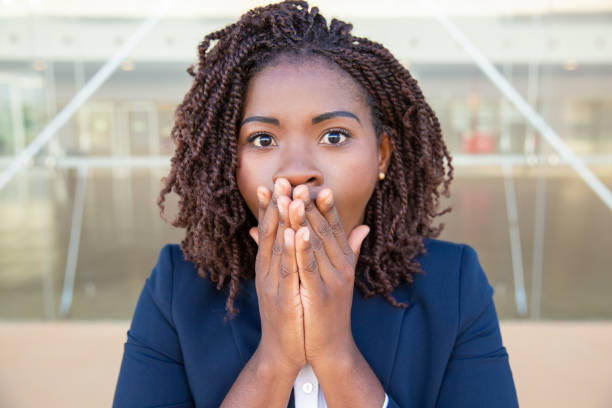 istock Shocked businesswoman closing mouth 1201112698