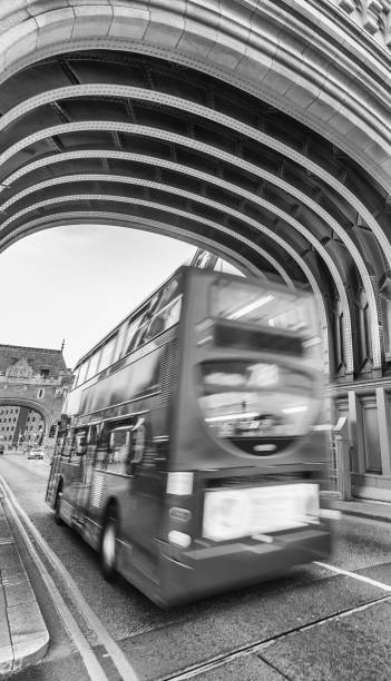 istock Red bus fast moving along Tower Bridge, London 1201112782