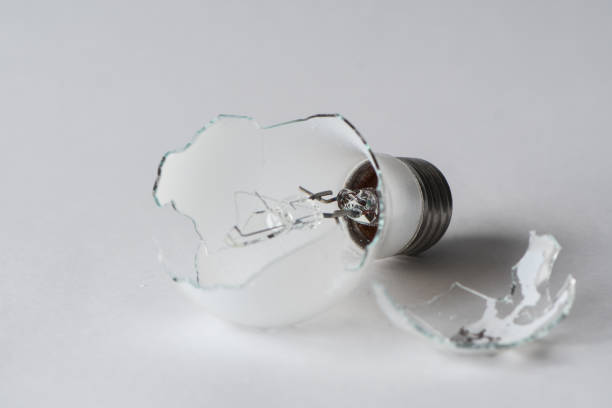 istock Broken light bulb isolated on white background with shattered piece of lightbulb. 1201112864