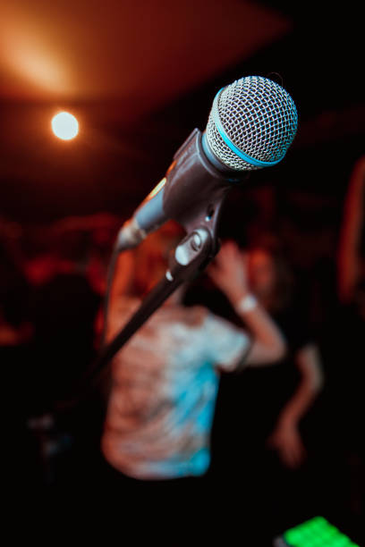 istock Public performance on stage Microphone on stage against a background of auditorium. Shallow depth of field. Public performance on stage. 1201113037