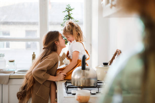 istock Two sisters play in a bright, stylish kitchen. Beautiful interior. 1201114725