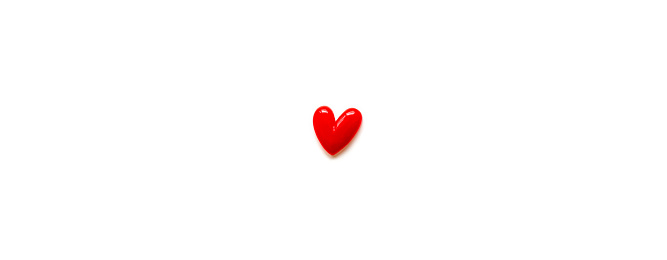 a small red heart and white background and copy space.