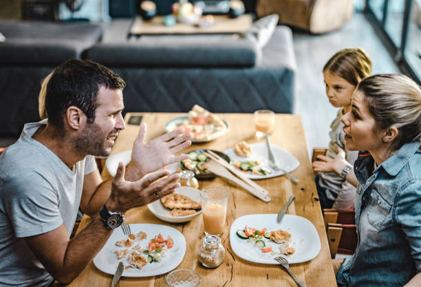 istock Young parents arguing while having lunch with their kids at home. 1201123250