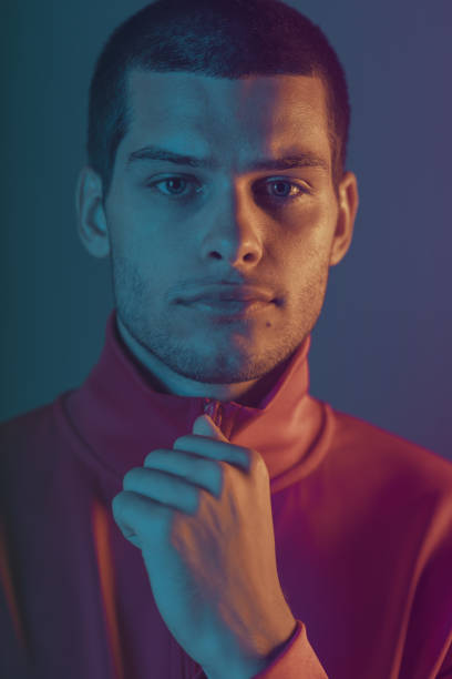 istock Studio close-up portrait of attractive male model. Color flash studio light 1201123406