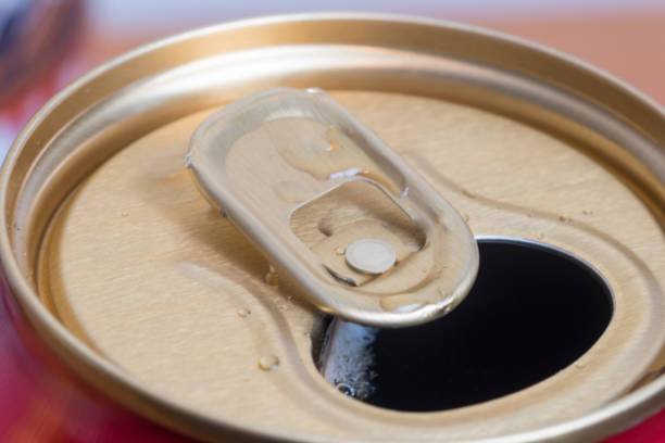 istock An opened aluminum can with some drink on can opener. 1201123923