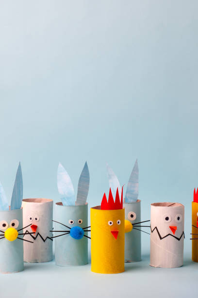istock Paper rabbit, chicken, egg for happy easter spring party. Easy crafts for kids on blue background, copy space, diy creative idea from toilet tube roll, recycle reuse eco concept 1201124428