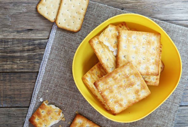 istock Crackers biscuit in yellow bowl put on the table 1201126882