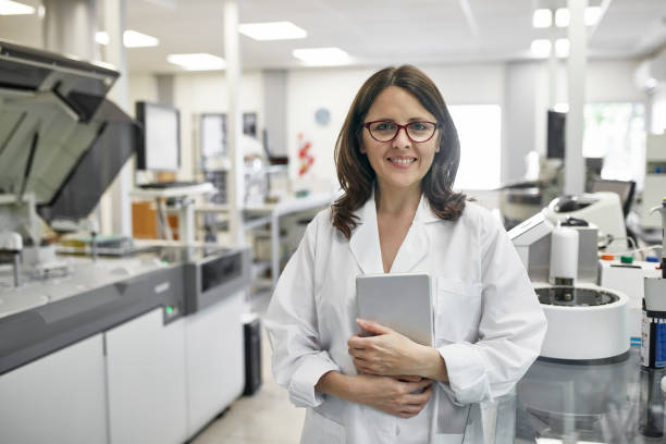 istock Mature Female Pathologist with Digital Tablet in Laboratory 1201133418