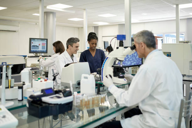 istock Multi-Ethnic Male and Female Pathology Laboratory Staff 1201133471