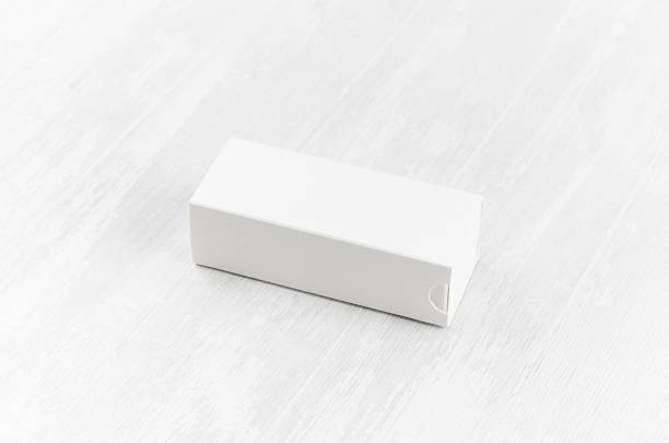 istock White blank closed paper rectangle box mock up on soft light white wood board side view for design, branding identity, advertising, presentation. 1201139030