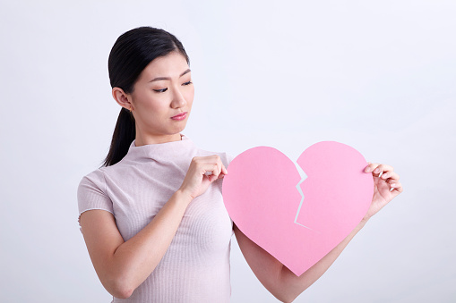 love emotion concept asian woman holding pink color heart shape cardboard