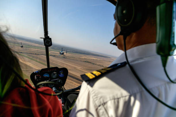 istock Flying with passenger behind other two helicopters 1201142313