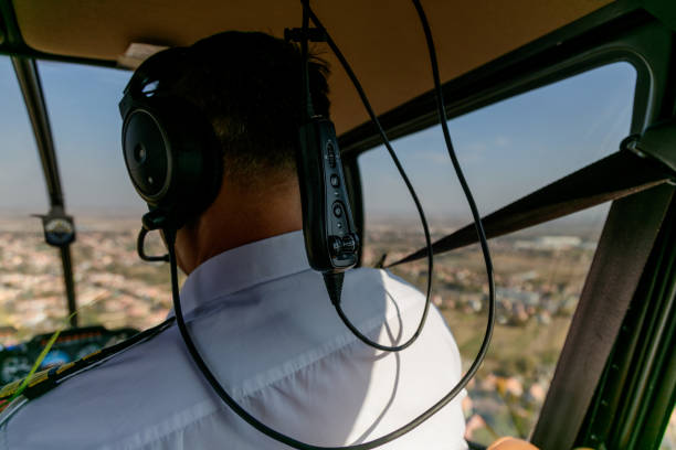 istock Rear view of a pilot flying helicopter 1201142329