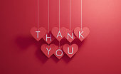 Thank You Writes over Red Heart Shapes Hanging over Red Background