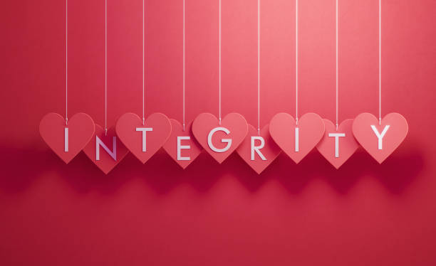 istock Integrity Writes over Red Heart Shapes Hanging over Red Background 1201142464