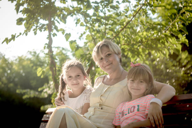 istock Happy mother with her small  daughters. 1201143494